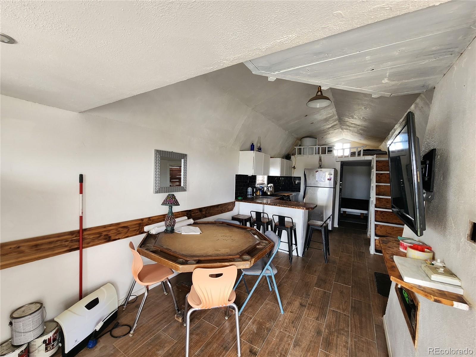 161 Fourmile Creek Road Hartsel, CO 80449 - Photo 18 of 31 a dining room with furniture and wooden floor