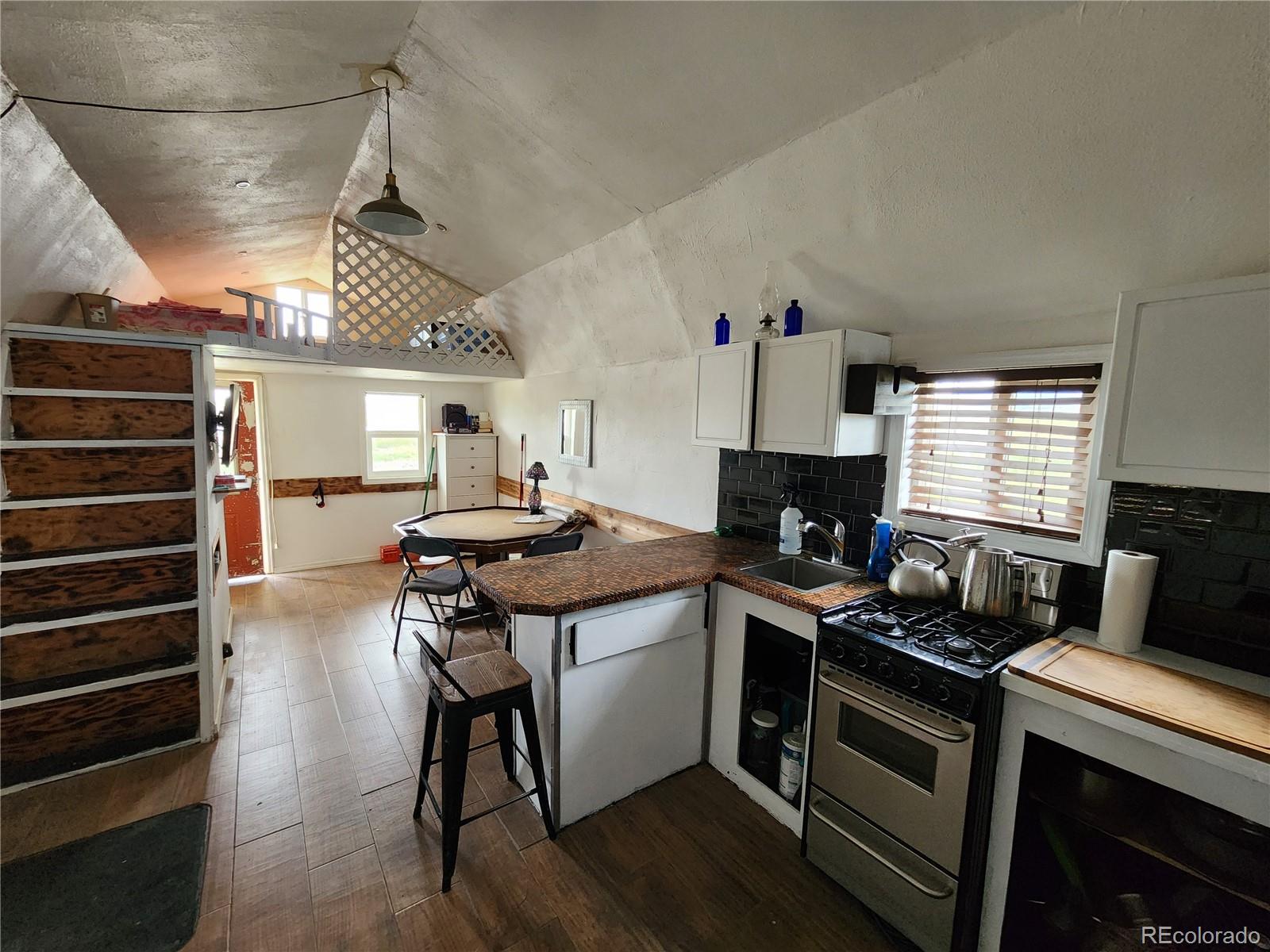 161 Fourmile Creek Road Hartsel, CO 80449 - Photo 20 of 31 a kitchen with a sink a stove and cabinets
