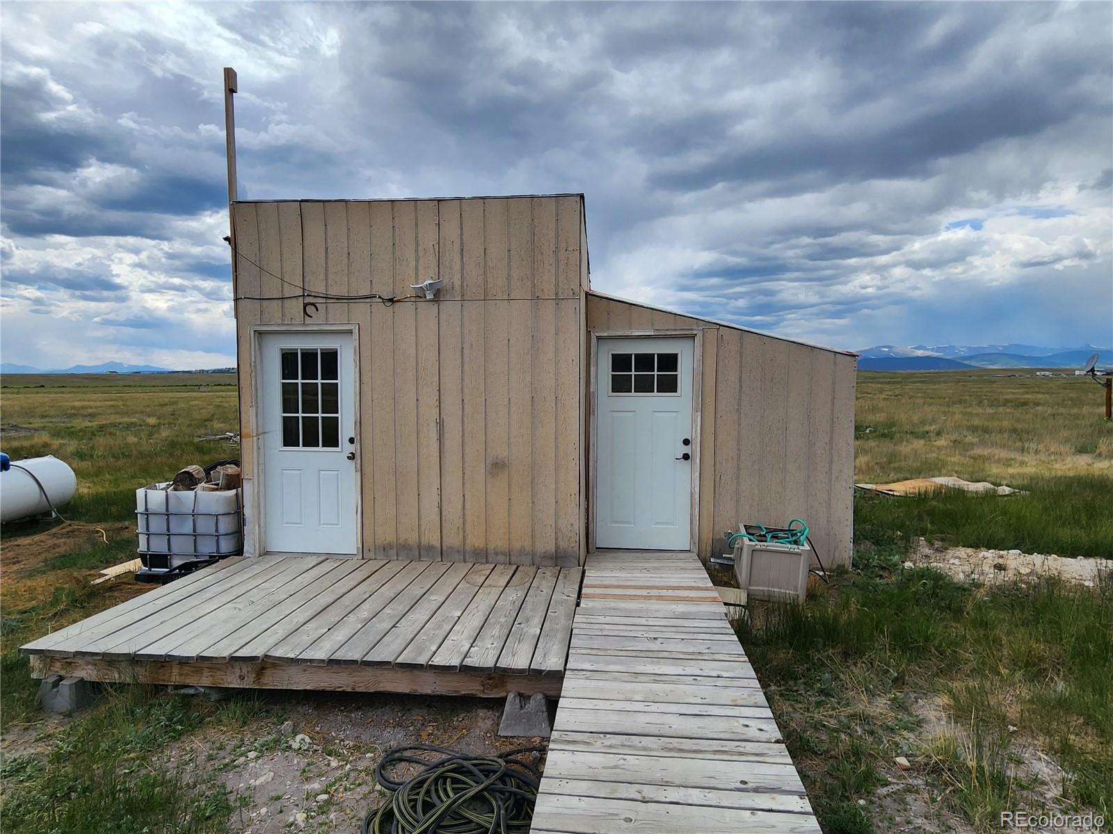 161 Fourmile Creek Road Hartsel, CO 80449 - Photo 10 of 31 a view of a balcony with chair and wooden floor