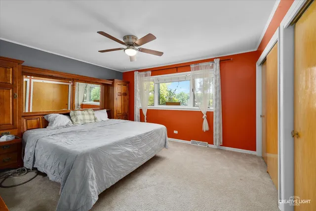 a bedroom with a large bed and a large window