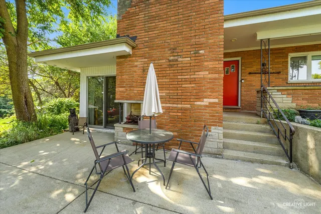 a patio with a patio table and chairs