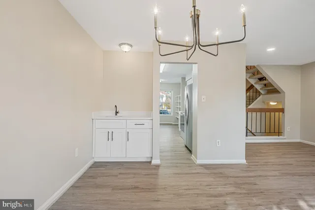 a view of a kitchen with a sink and wooden floor