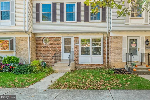 front view of a brick house with a large windows