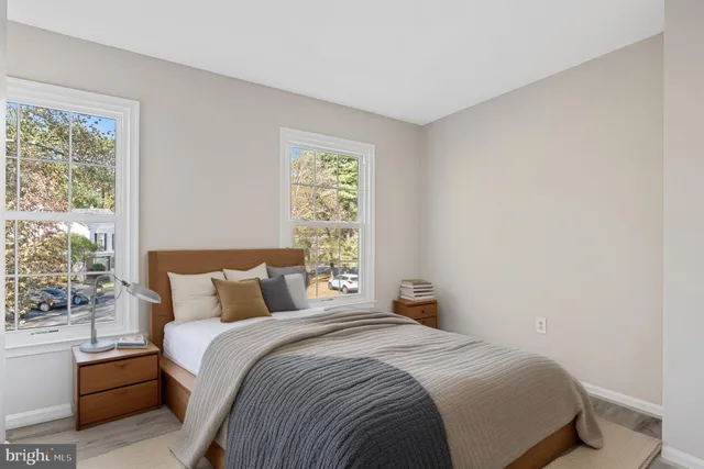 a bedroom with a bed and a potted plant