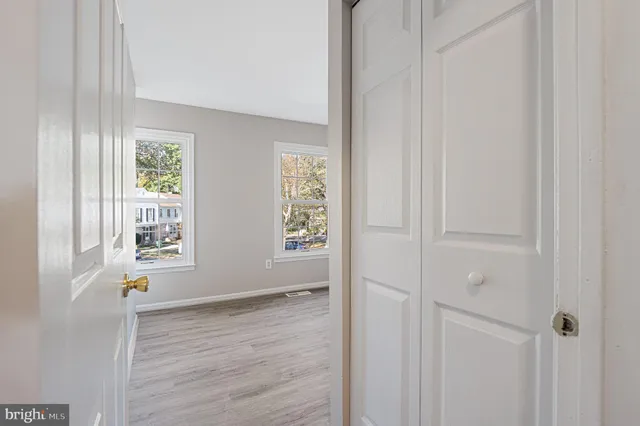 a view of an empty room with wooden floor