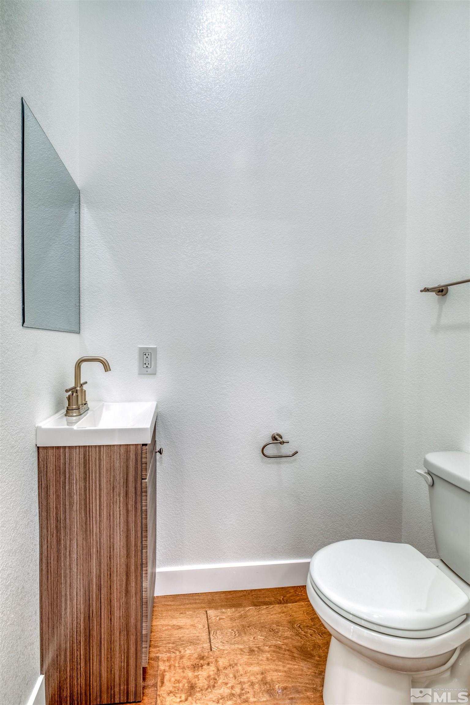 335 Roberts Street Reno, NV 89502 - Photo 12 of 18 a white toilet sitting next to a bathroom sink