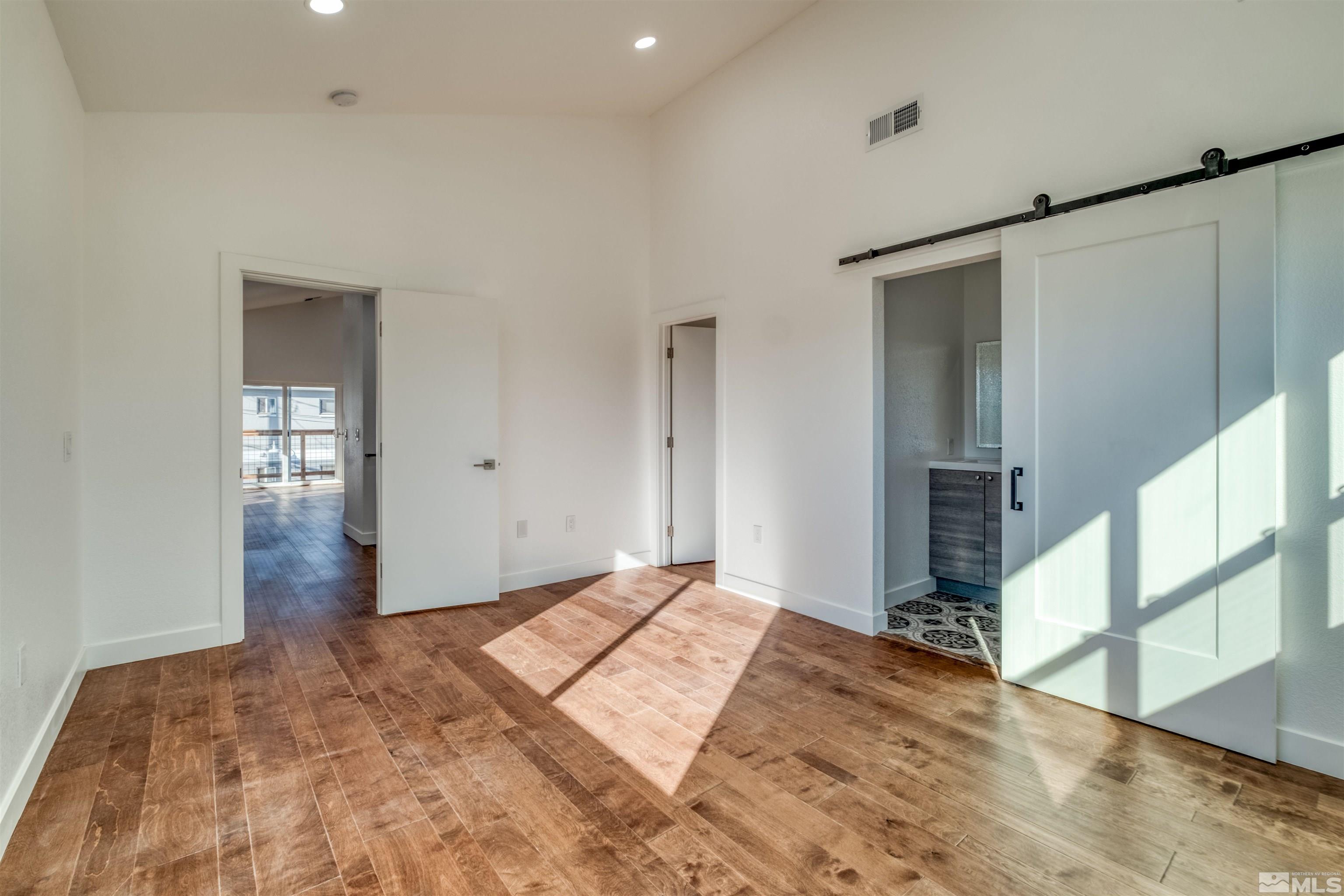 335 Roberts Street Reno, NV 89502 - Photo 13 of 18 a bedroom with a bed and a window