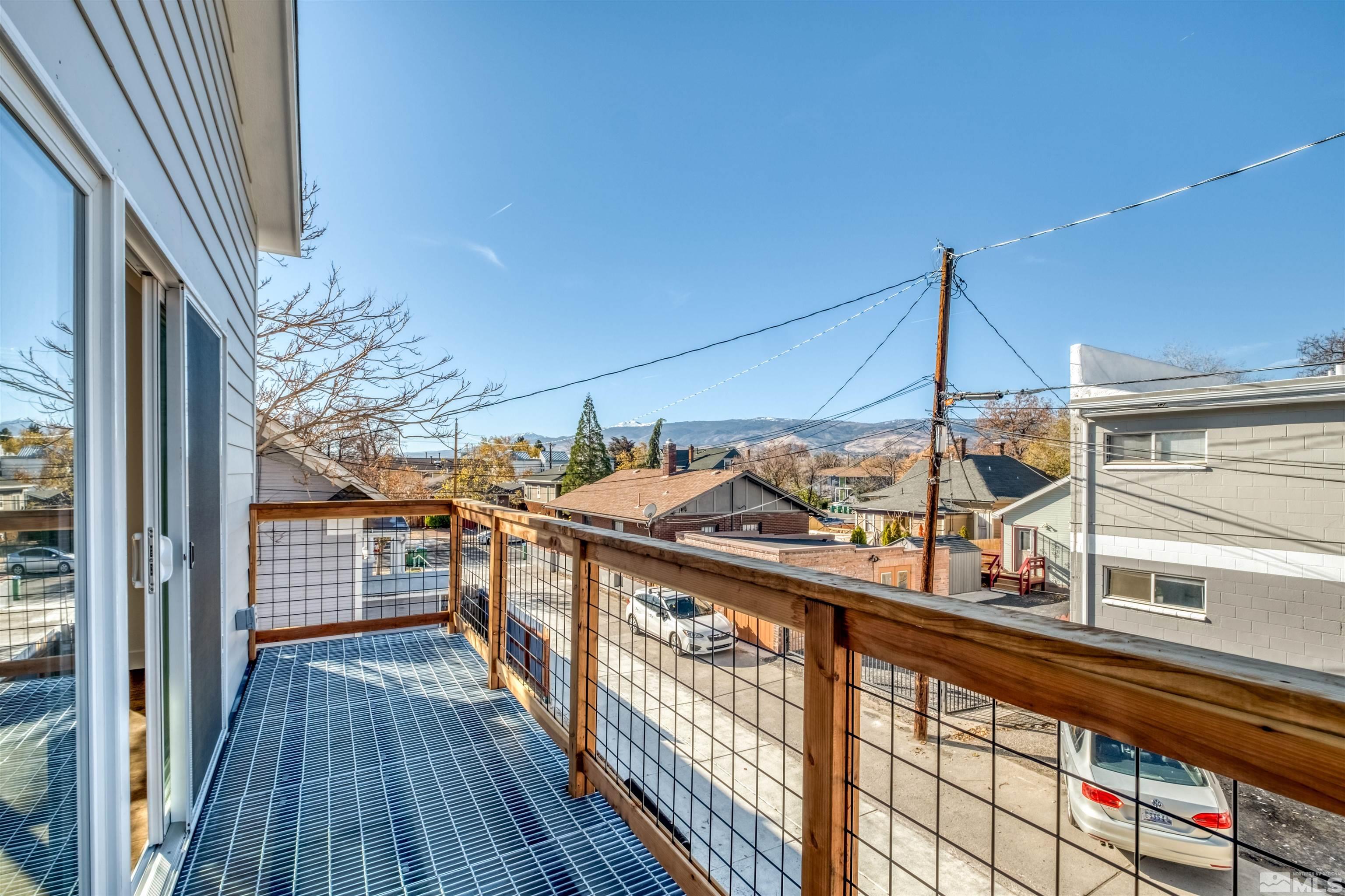 335 Roberts Street Reno, NV 89502 - Photo 4 of 18 a view of a balcony with wooden floor and iron stairs