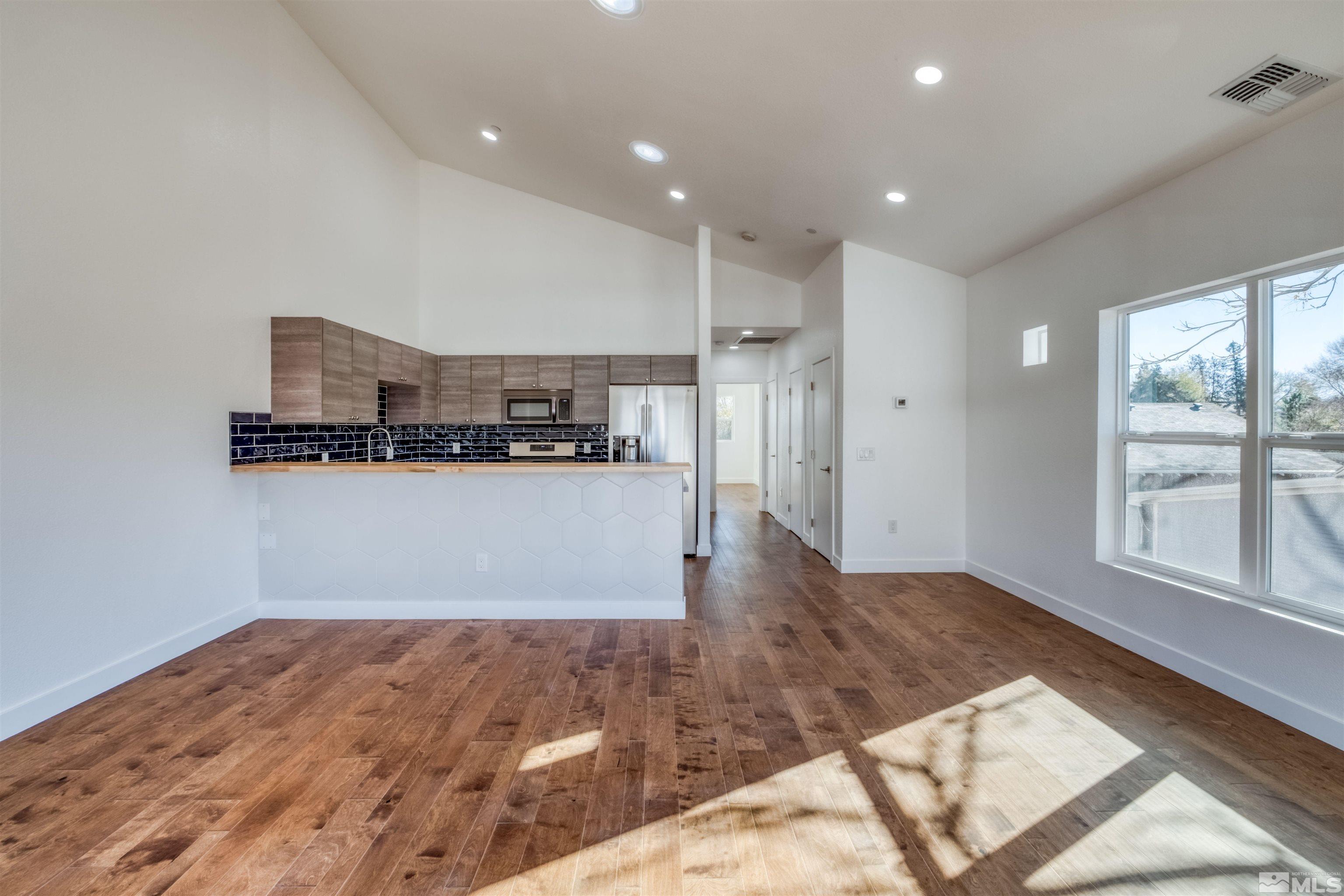 335 Roberts Street Reno, NV 89502 - Photo 9 of 18 a view of kitchen with wooden floor and window