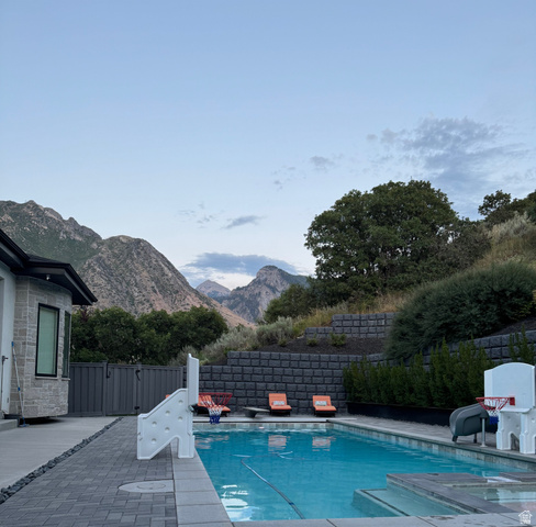614 East High Lane Alpine, UT 84004 - Photo 17 of 75 View of swimming pool with patio surround, a fenced backyard, and a mountain view