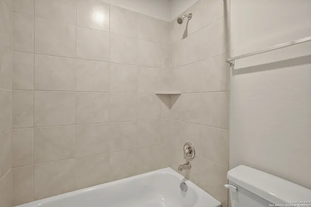 a bathroom with a bathtub and toilet