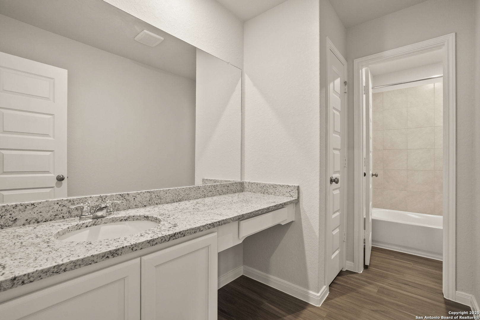 13624 Helton Pass St. Hedwig, TX 78152 - Photo 23 of 35 a bathroom with a granite countertop sink and a mirror