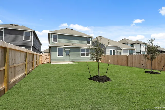a view of a house with a backyard