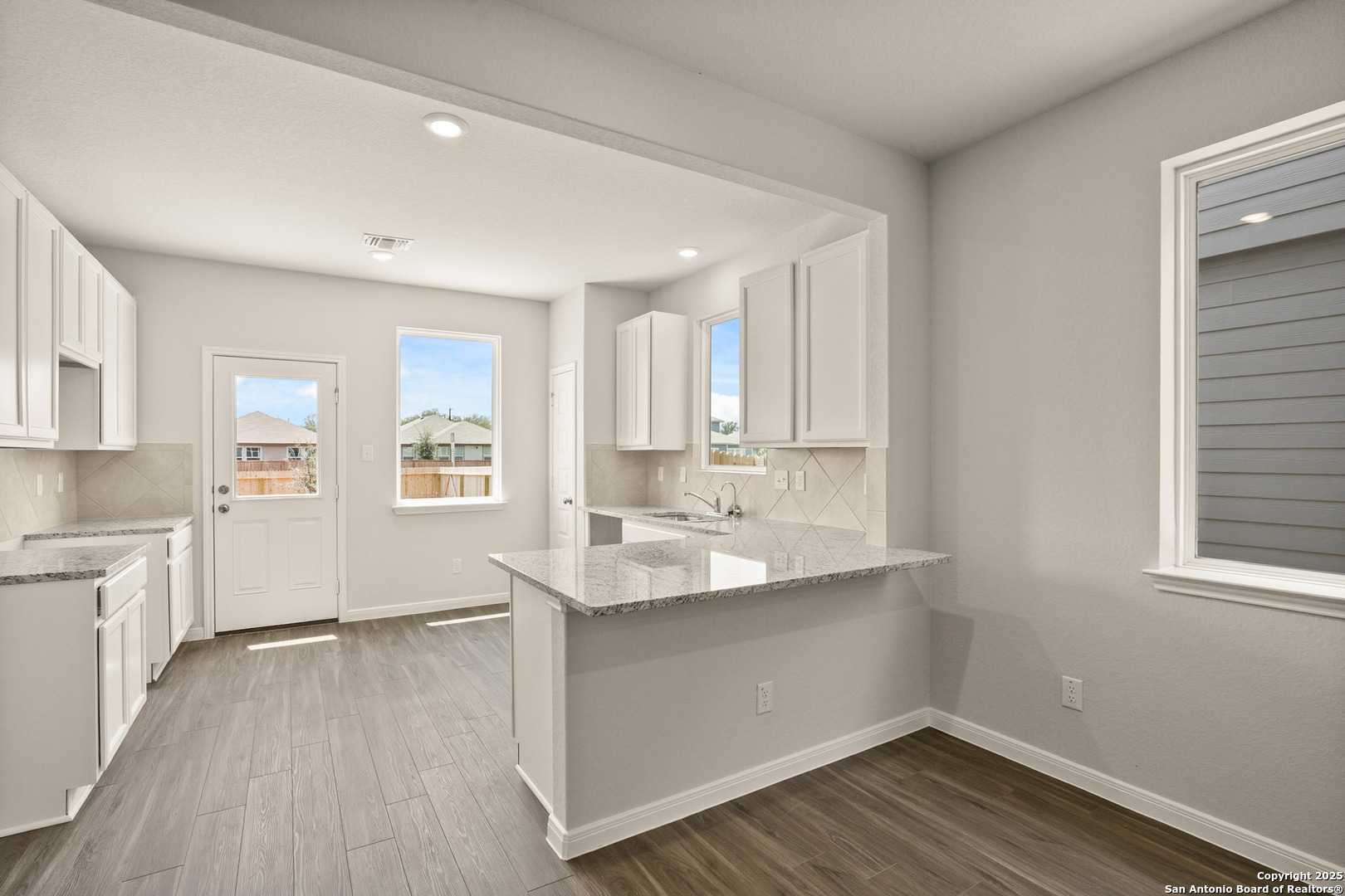 13624 Helton Pass St. Hedwig, TX 78152 - Photo 4 of 35 a view of a kitchen with wooden floor and a window