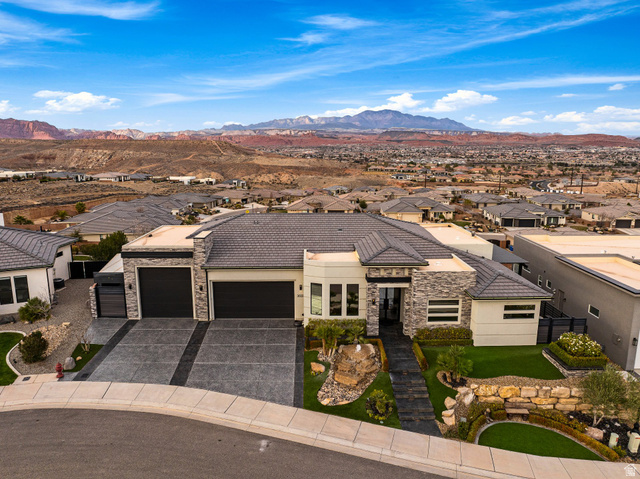 3022 West Sesia Way St. George, UT 84770 - Photo 14 of 52 View of front facade featuring stone siding, a garage, a residential view, and a mountain view