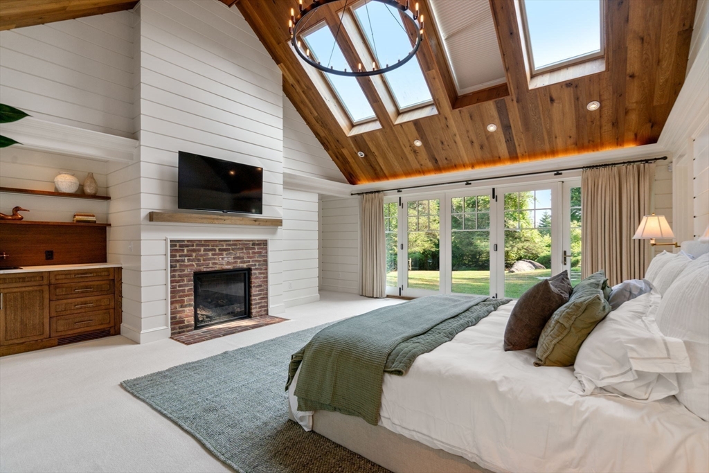 339 Pope Road Concord, MA 01742 - Photo 14 of 40 a large white bed in a bedroom next to a window