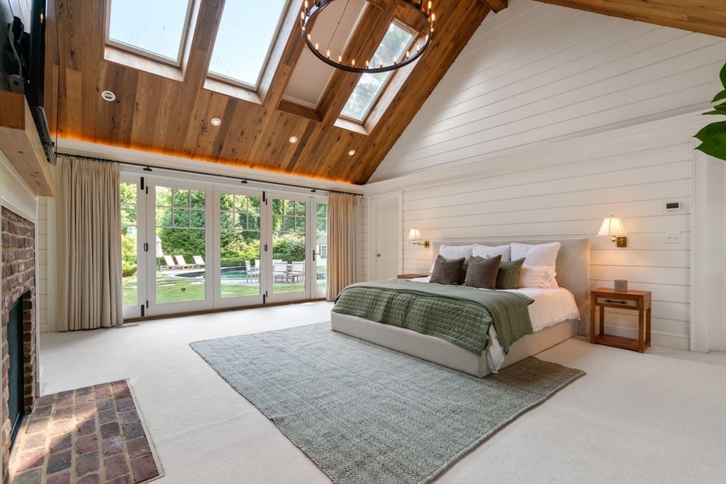 339 Pope Road Concord, MA 01742 - Photo 15 of 40 a spacious bedroom with a large bed and a large window