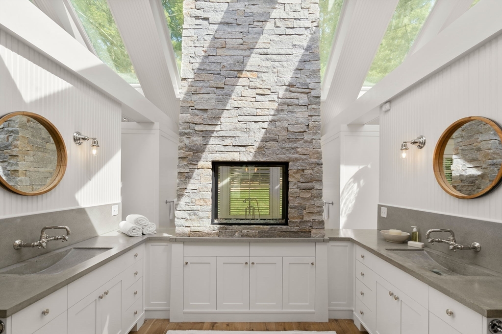339 Pope Road Concord, MA 01742 - Photo 16 of 40 a bathroom with a granite countertop sink and a mirror