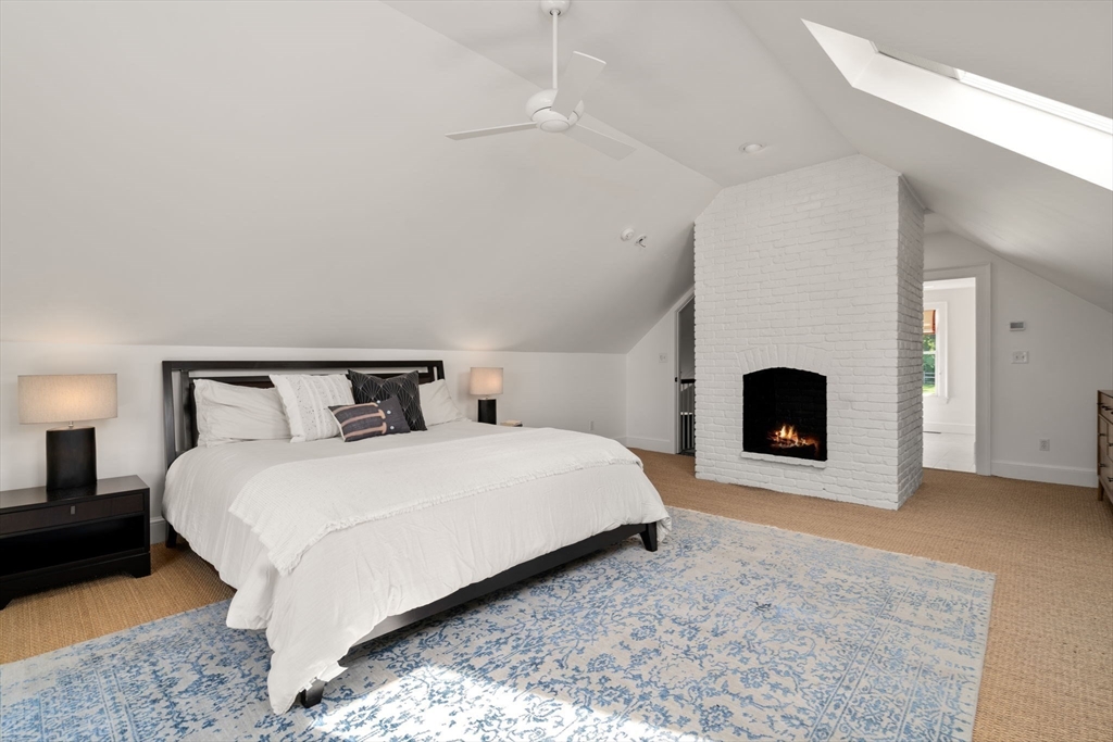 339 Pope Road Concord, MA 01742 - Photo 27 of 40 a spacious bedroom with a bed and a fireplace