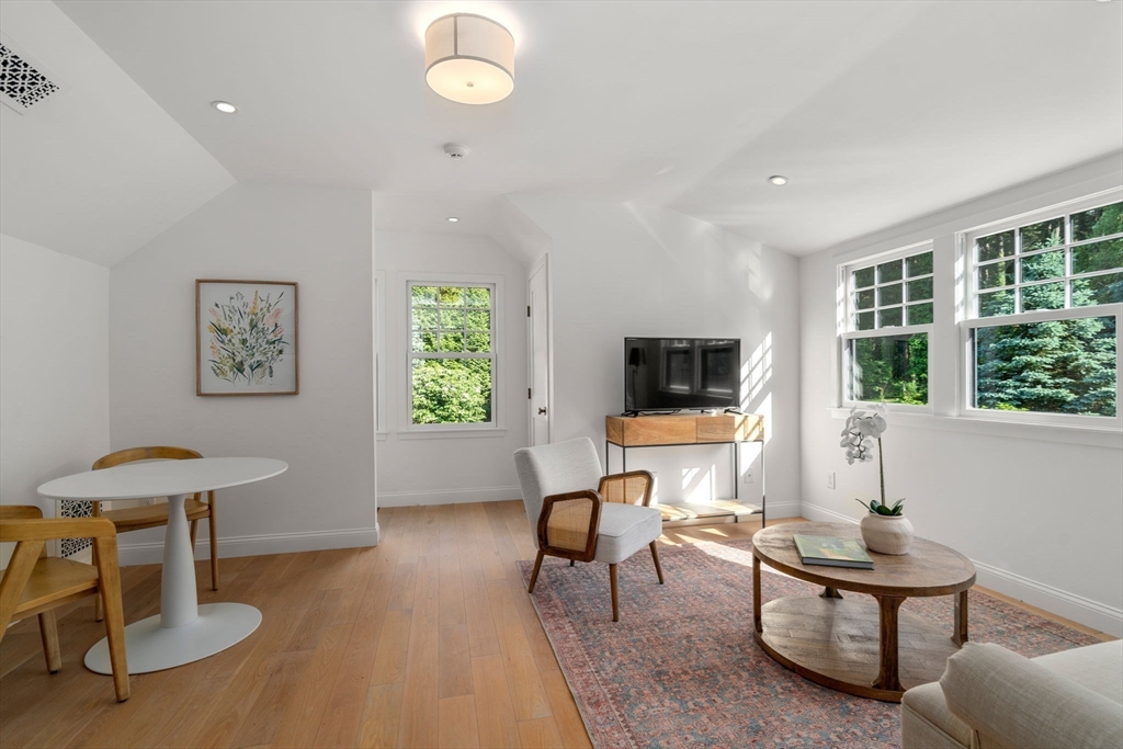 339 Pope Road Concord, MA 01742 - Photo 30 of 40 a living room with furniture a window and a flat screen tv
