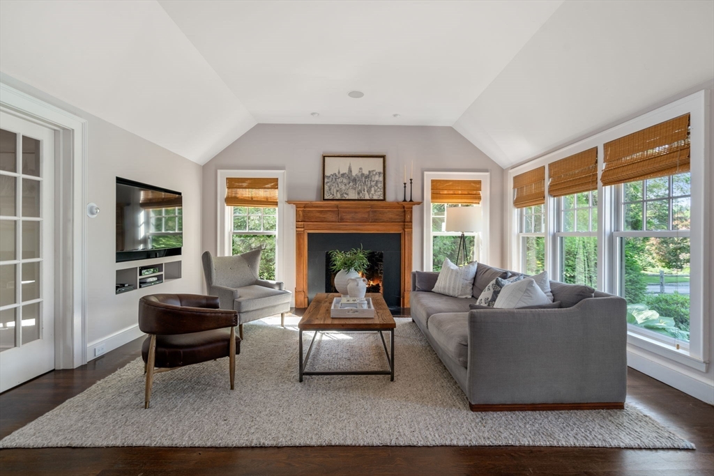 339 Pope Road Concord, MA 01742 - Photo 6 of 40 a living room with furniture a large window and a fireplace
