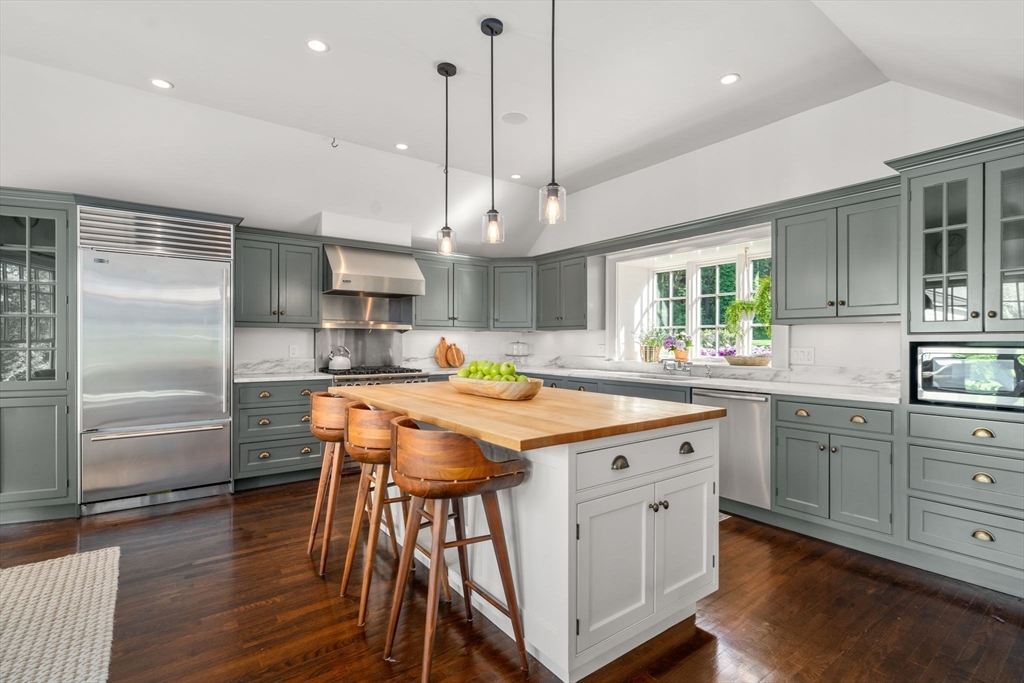 339 Pope Road Concord, MA 01742 - Photo 8 of 40 a kitchen with kitchen island a wooden floor and white appliances