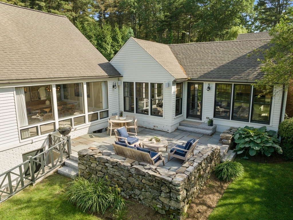 339 Pope Road Concord, MA 01742 - Photo 10 of 40 a view of a house with backyard sitting area and garden