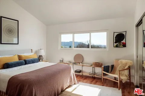 a bedroom with a bed and a window