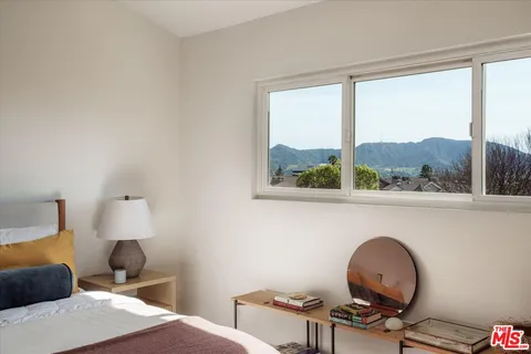 a bedroom with furniture and a window