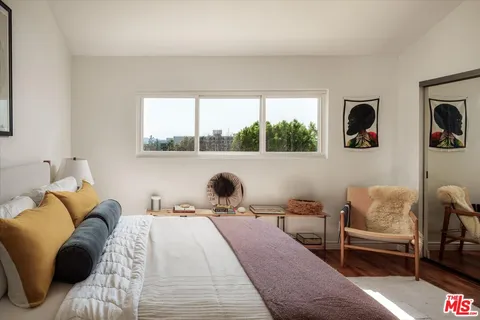 a bed room with a bed and a chair