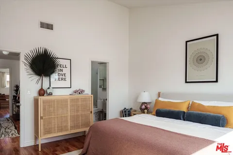 a bedroom with a bed and a chair