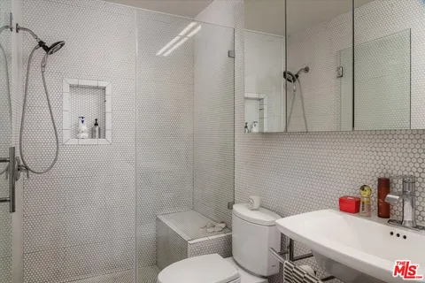 a bathroom with a toilet sink and shower