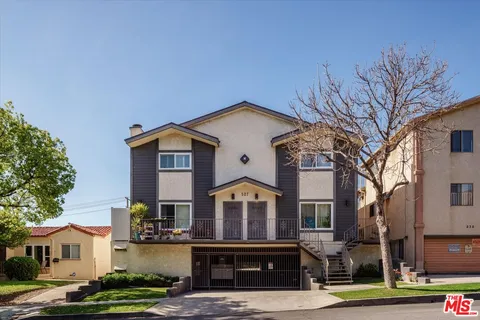 a front view of a residential houses with yard