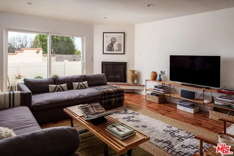 a living room with furniture a large window and a flat screen tv