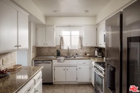 a kitchen with a sink stove and refrigerator