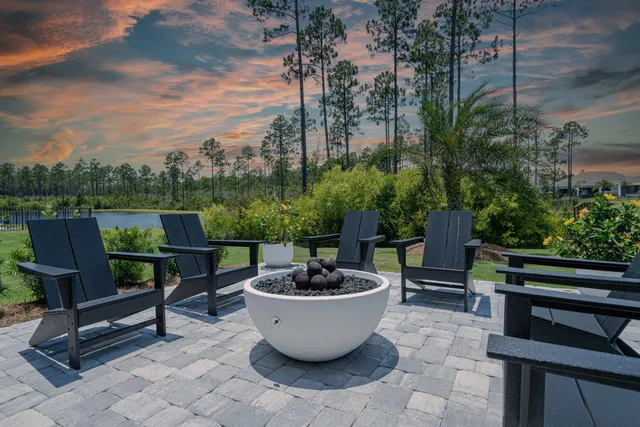 a view of a patio with chairs and plants