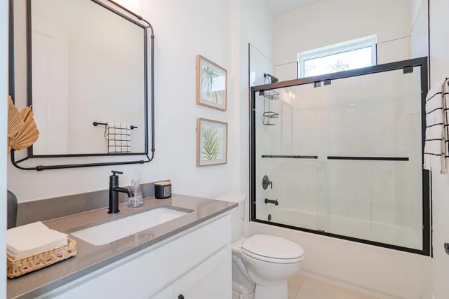 a kitchen with stainless steel appliances kitchen island granite countertop a table chairs in it and wooden floors