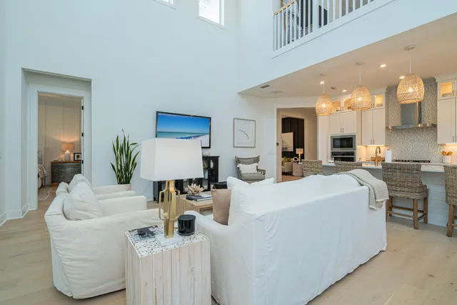 a living room with furniture flowerpot and wooden floor