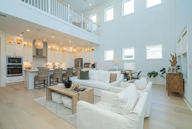 a living room with furniture and a view of kitchen