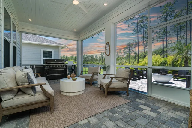 a living room with furniture and a floor to ceiling window