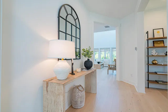 a living room with furniture and a painting on the wall