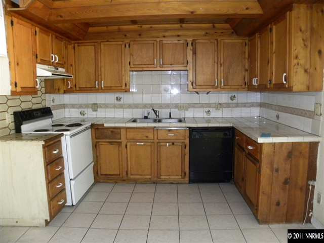 1755 Castle Way Reno, NV 89512 - Photo 4 of 10 a kitchen with a stove top oven sink and cabinets