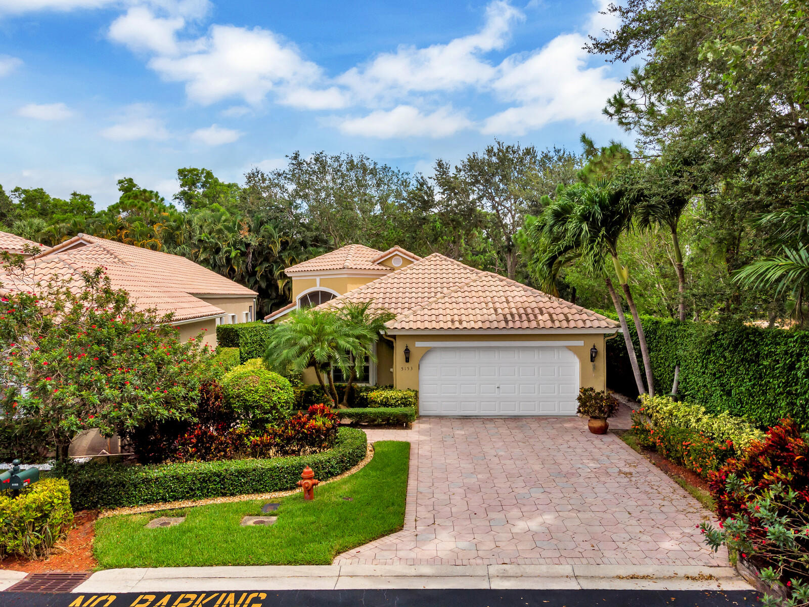 5153 Brookview Drive Boynton Beach, FL 33437 - Photo 3 of 44 a front view of a house with garden