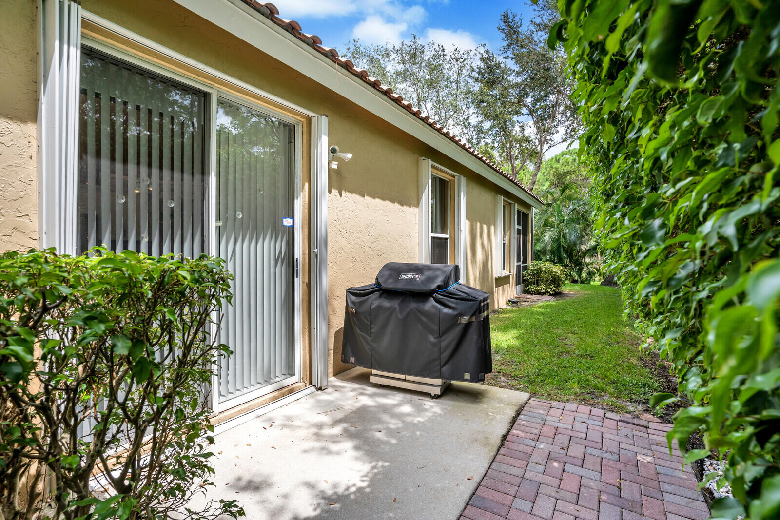 5153 Brookview Drive Boynton Beach, FL 33437 - Photo 36 of 44 a backyard of a house with table and chairs
