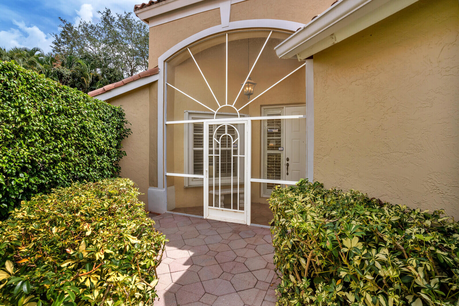 5153 Brookview Drive Boynton Beach, FL 33437 - Photo 6 of 44 a view of a house with a small yard and plants