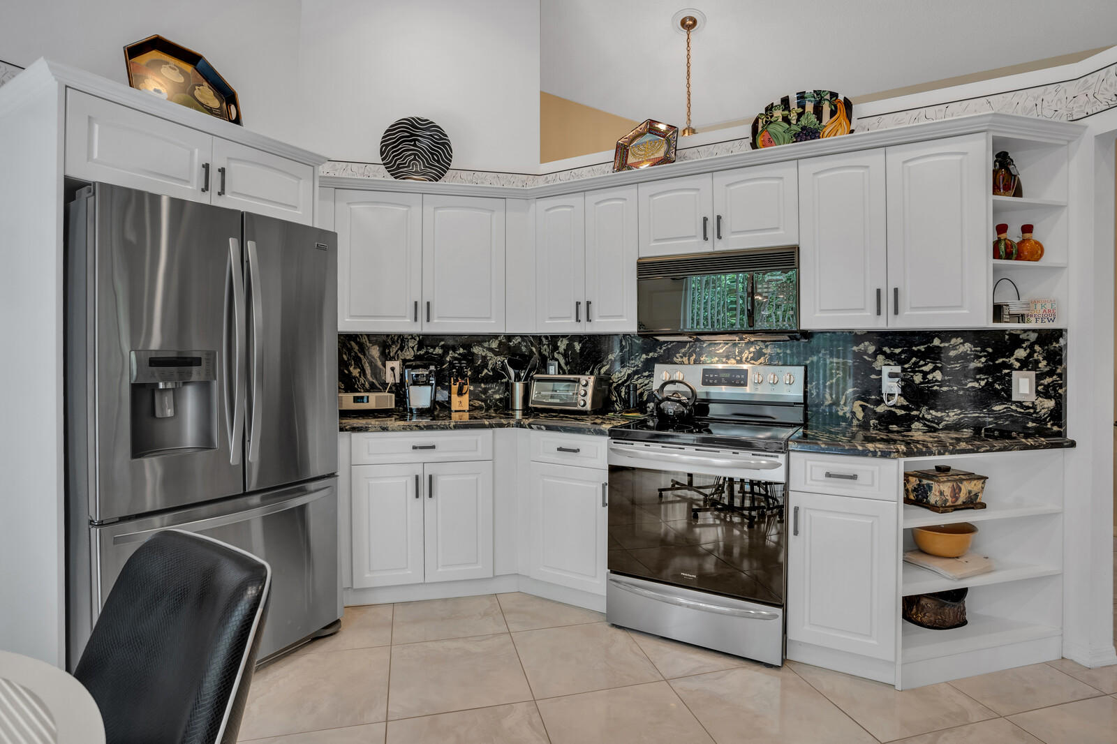 5153 Brookview Drive Boynton Beach, FL 33437 - Photo 9 of 44 a kitchen with stainless steel appliances granite countertop a refrigerator sink and stove