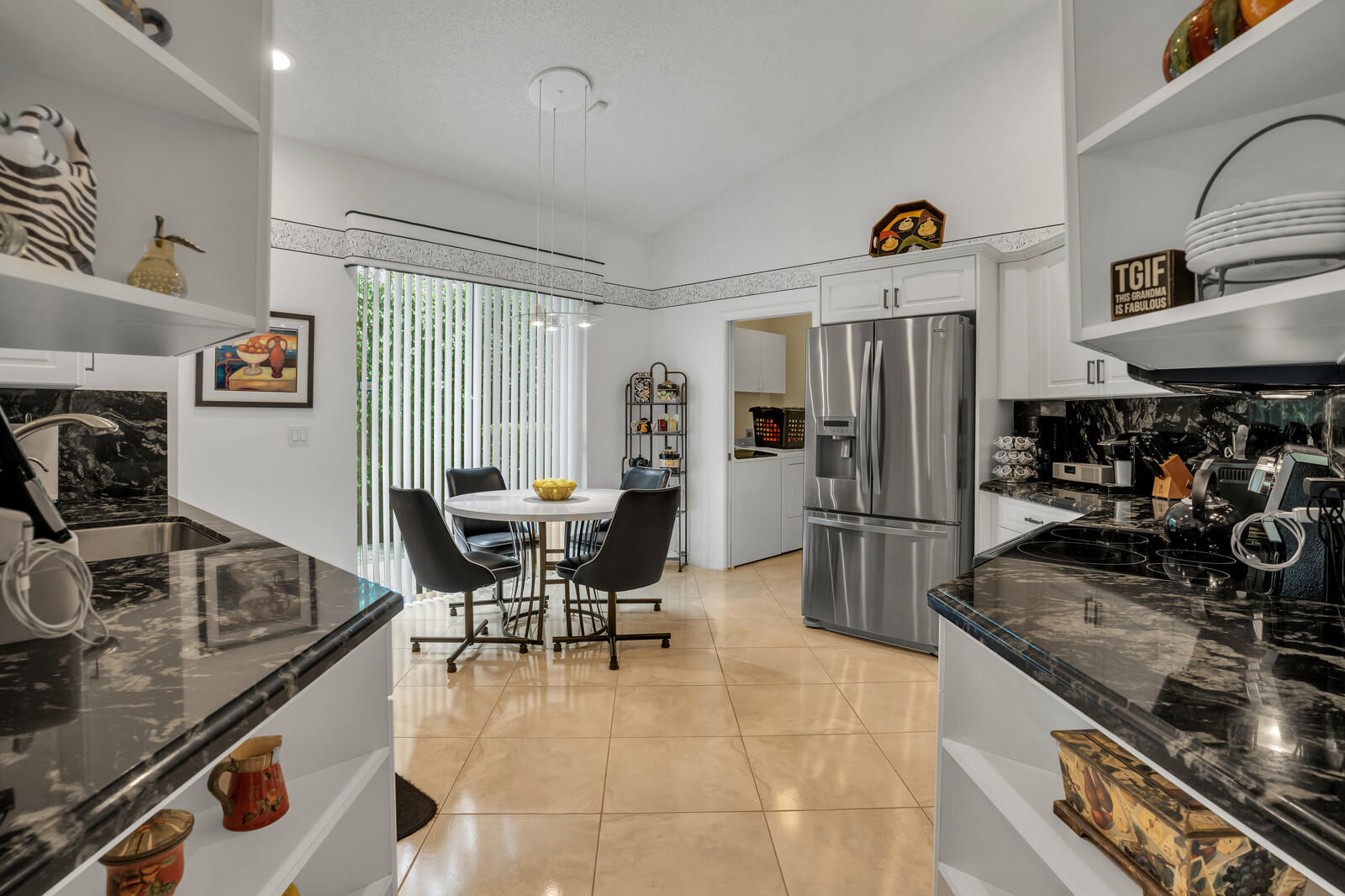 5153 Brookview Drive Boynton Beach, FL 33437 - Photo 10 of 44 a kitchen with stainless steel appliances granite countertop a sink stove and refrigerator