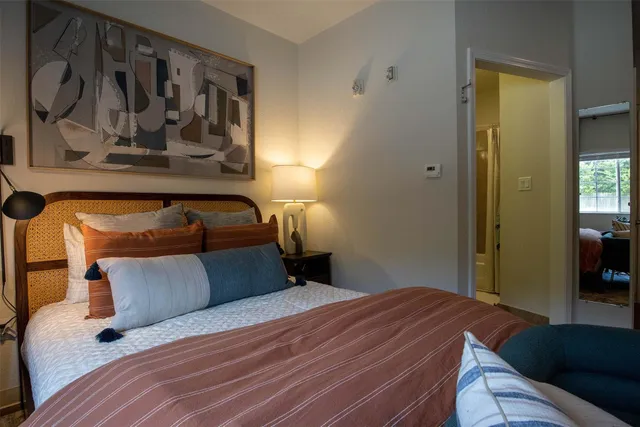 a bedroom with furniture and a flat screen tv