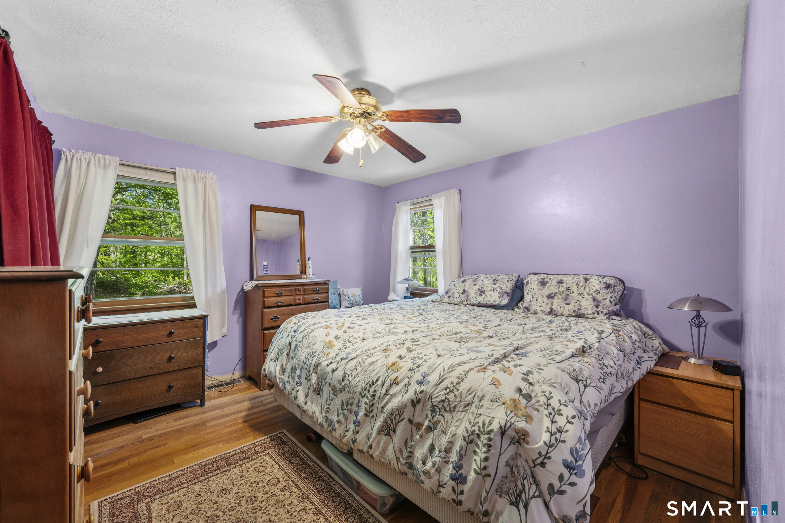 121 River Road Preston, CT 06365 - Photo 20 of 37 a bedroom with a bed and a chandelier