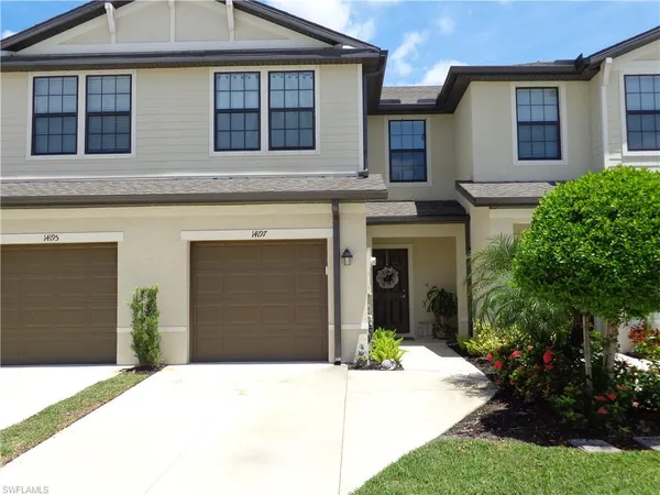 a front view of a house with a yard and garage